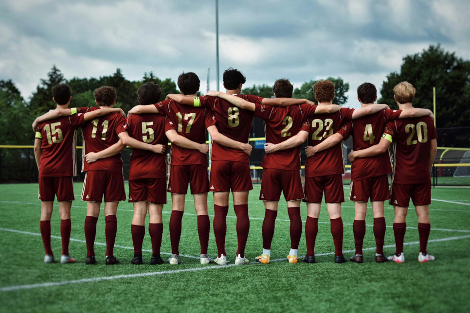 High school boys soccer team with arms around each other