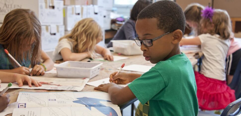 students sitting at a table in a classroom