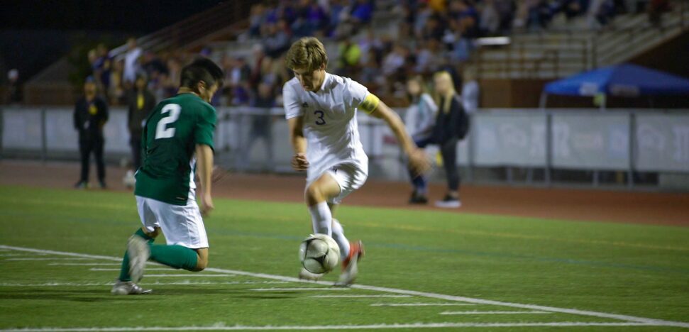 The Sumner captain takes on a Skyline defender at the 2018 Washington State Soccer Championship semifinal