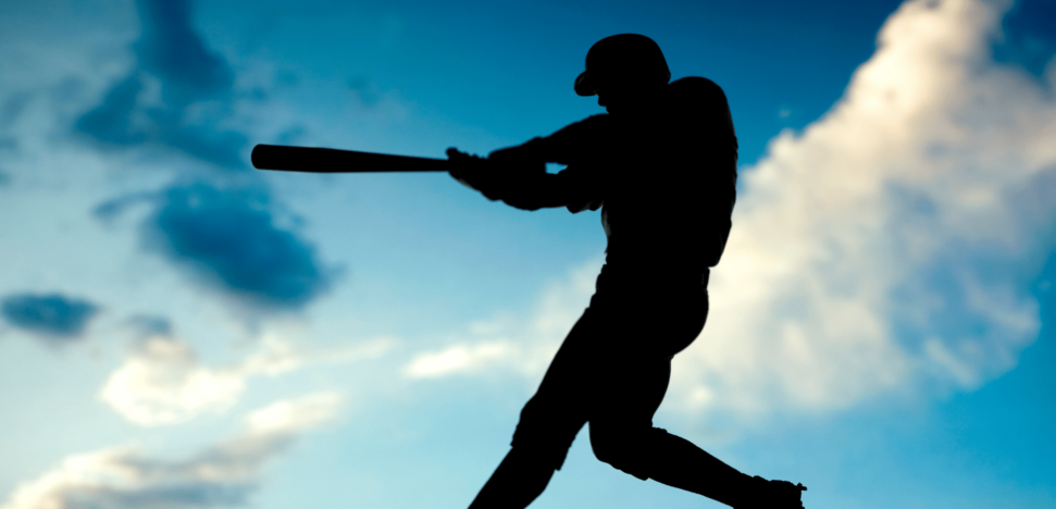 silhouette of batter swinging a bat