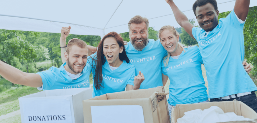 volunteers with arms raised