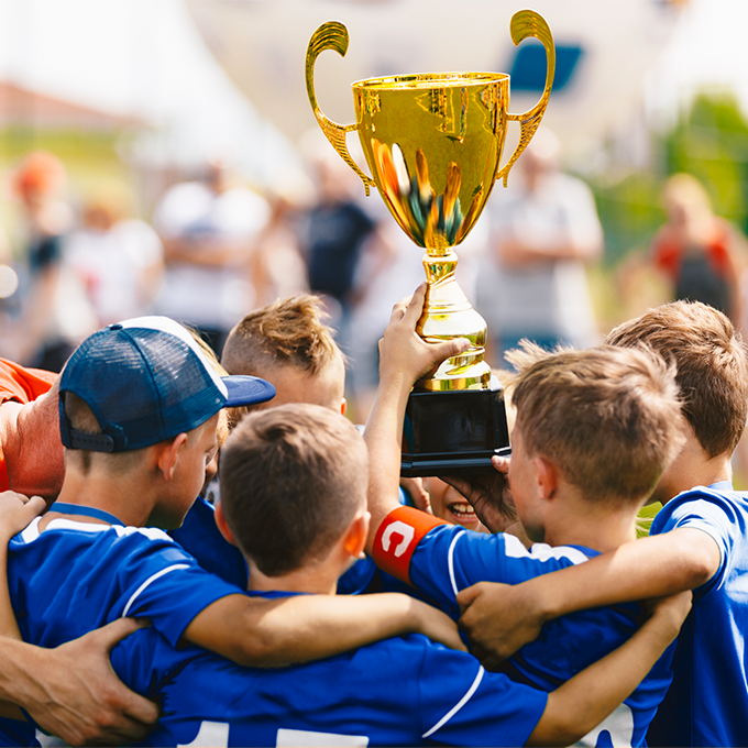 Baseball team holding up a championship trophy.