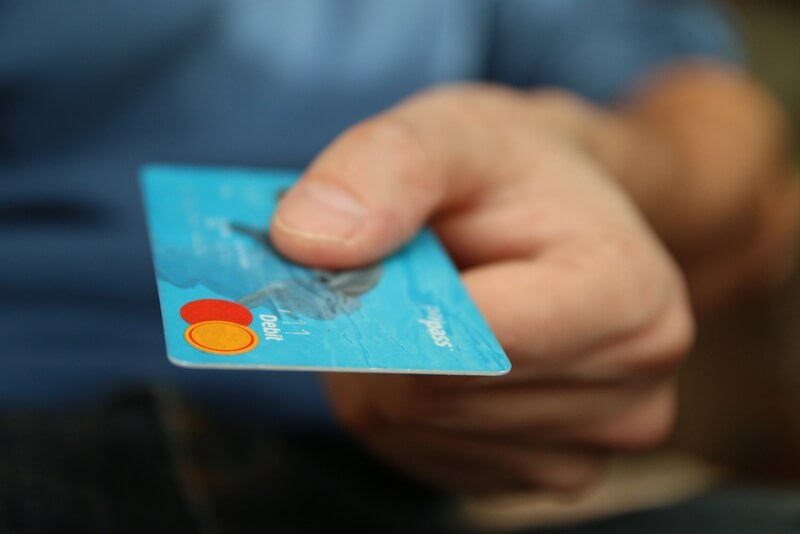 man handing over his debit card